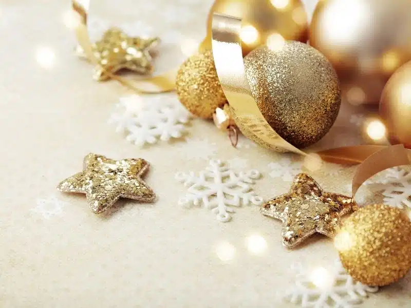 Glitter gold orb and star ornaments with snowflakes